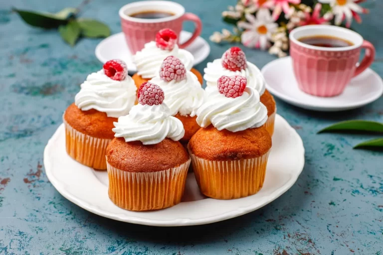 cupcakes-decorated-whipped-cream-frozen-raspberries_114579-7878